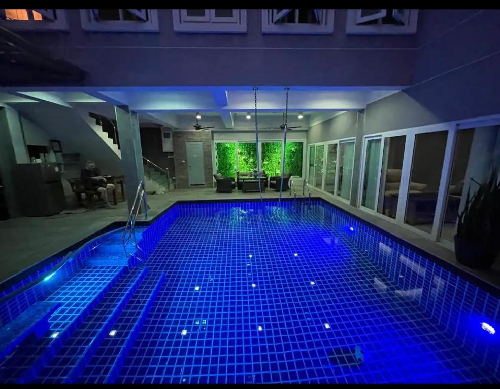 a swimming pool with blue lights in a house at Michelle house pool villa in Pattaya South