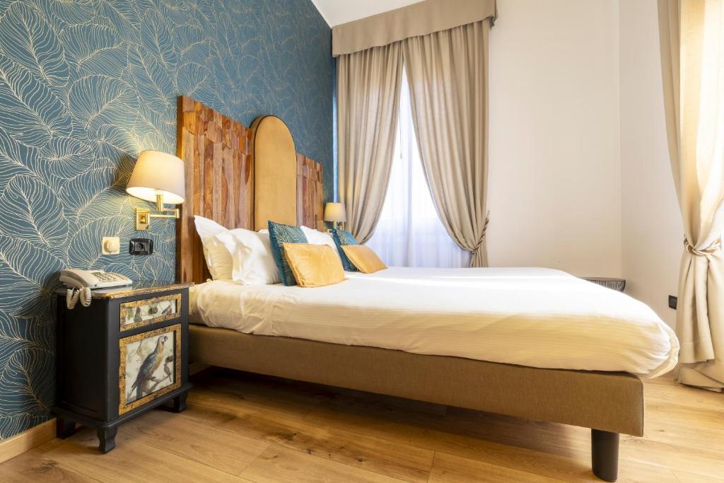 Postel nebo postele na pokoji v ubytování Hotel Bagliori