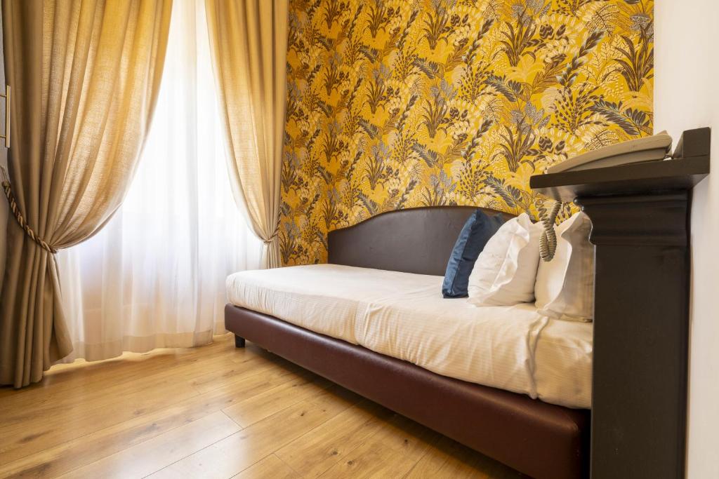 Postel nebo postele na pokoji v ubytování Hotel Bagliori