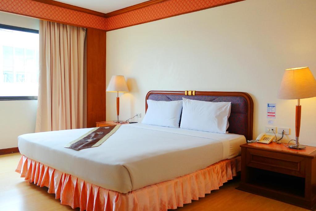 Postel nebo postele na pokoji v ubytování Grand Park Hotel