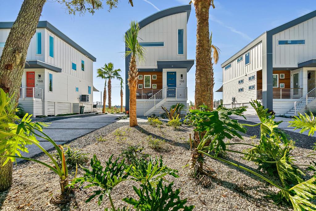 a row of buildings with palm trees and a sidewalk at 196 Riberia - Downtown Waterfront Luxury Home in Saint Augustine