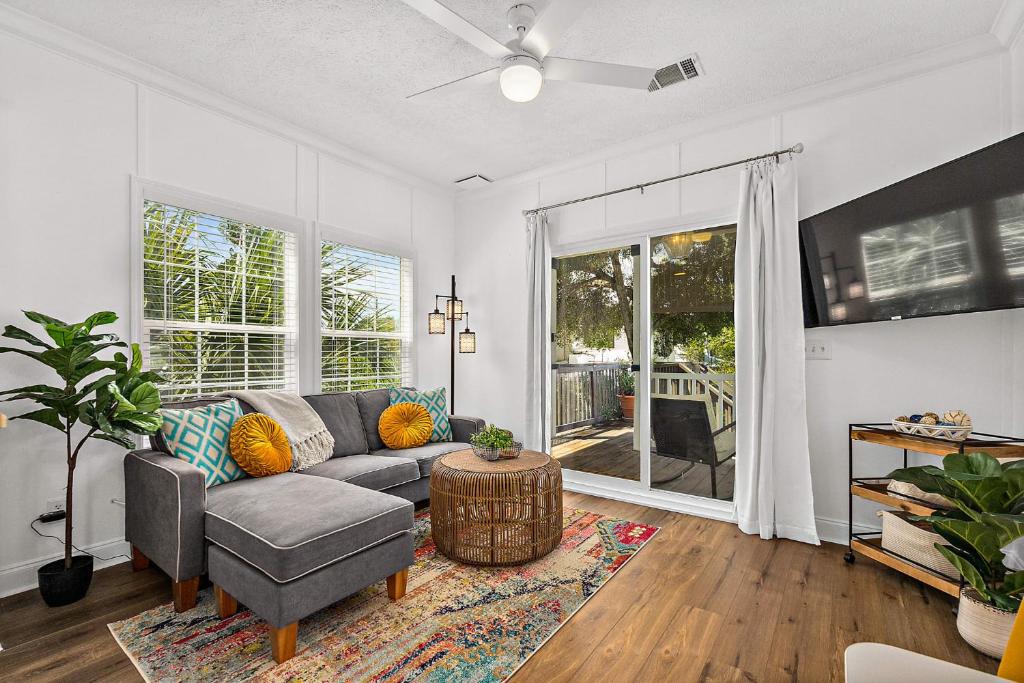 a living room with a couch and a table at Treetop Cottage - 3 blocks from Historic District in St. Augustine