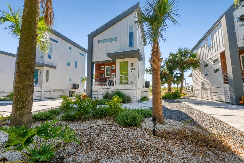 a building with palm trees in front of it at 194 Riberia - Downtown Waterfront Luxury Home in Saint Augustine