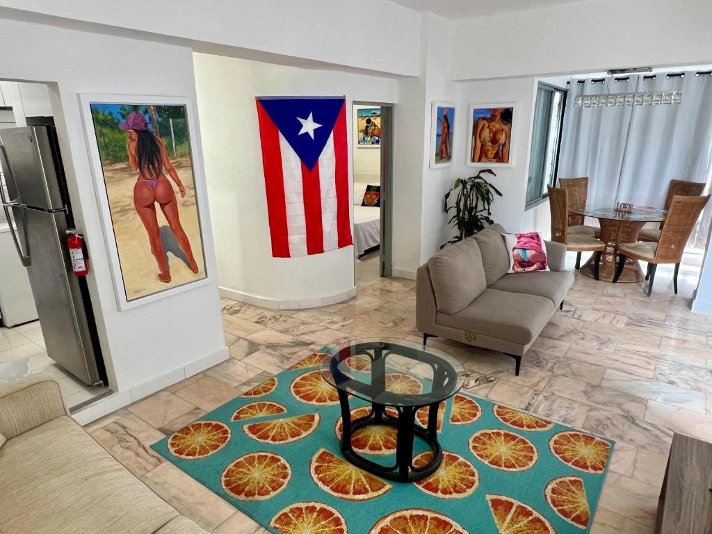 a living room with a couch and a table on a rug at In the heart of Condado a 2 Bedroom Apartment Balcony in San Juan
