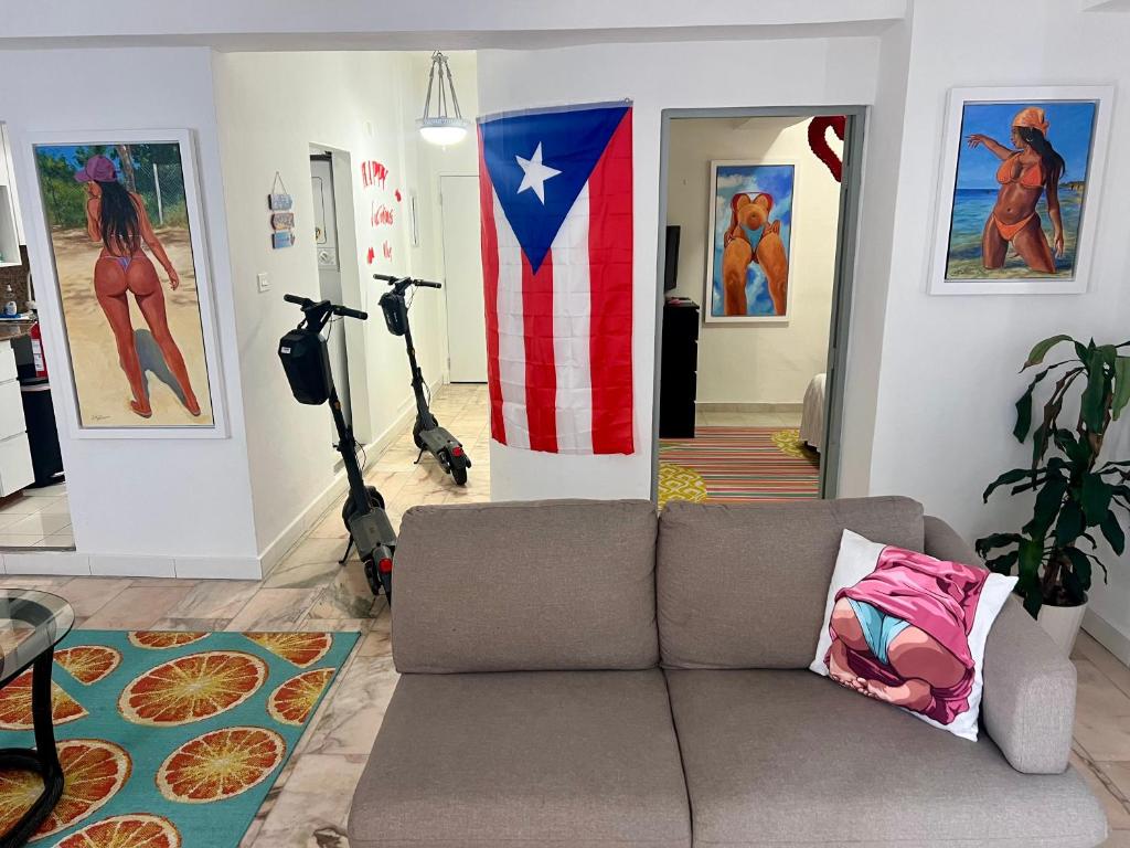 a living room with a couch and an american flag at Condado Paradise Tantra Apartment in San Juan