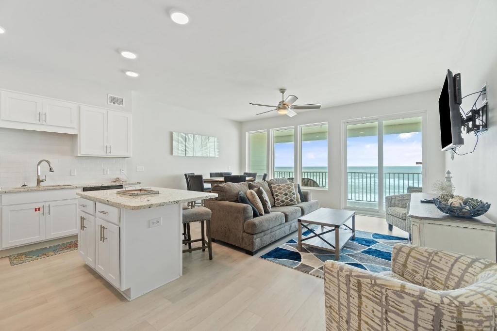 a kitchen and living room with a view of the ocean at Sea Glass 405 by Vacation Homes Collection in Gulf Shores
