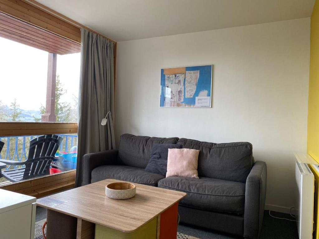 a living room with a couch and a table at Appartement Les Arcs 1800, 3 pièces, 8 personnes - FR-1-346-312 in Arc 1800