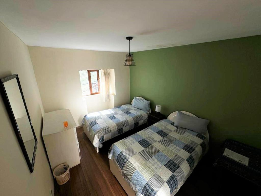 A bed or beds in a room at Hospedaje Milenio