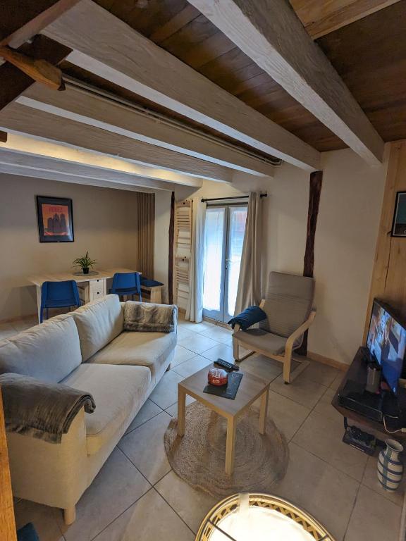 a living room with a couch and a table at La maison du 146 in Flavin