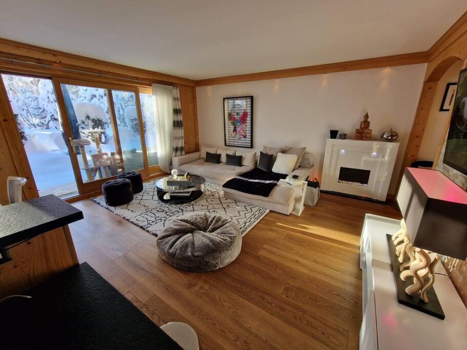 a living room with a couch and a table at Le Serenity - bright - cozy - central in Crans-Montana