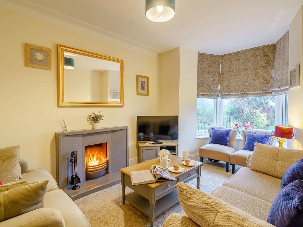 a living room with a couch and a fireplace at 4 Bed in Broughton - in - Furness 90412 in Duddon