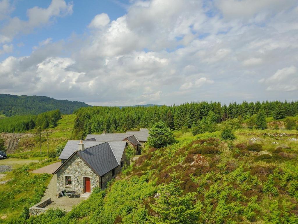 a house on top of a hill with trees at 1 Bed in Cairnbaan CA304 in Lochgilphead