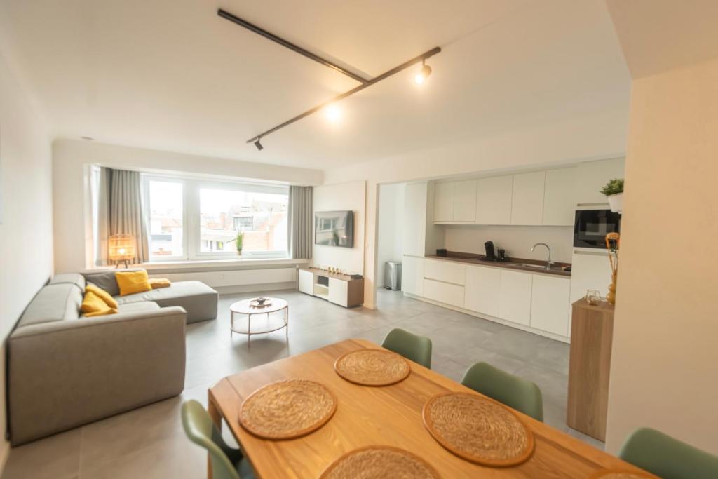 a living room with a table and a couch at Ostend Center Luxury Top Floor Apartment with Free Parking in Ostend