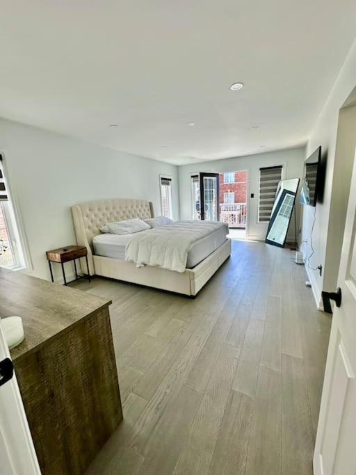 a large bedroom with a bed and a wooden floor at Private Luxury Full Home in Markham in Markham