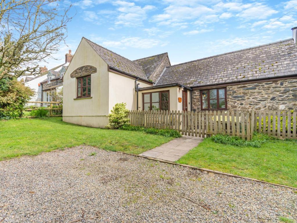 a house with a wooden fence in the yard at 2 Bed in Trefin 94123 in Trevine