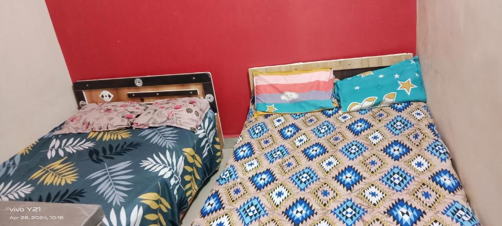 two beds sitting next to each other in a room at Manchaman home stay in Ujjain