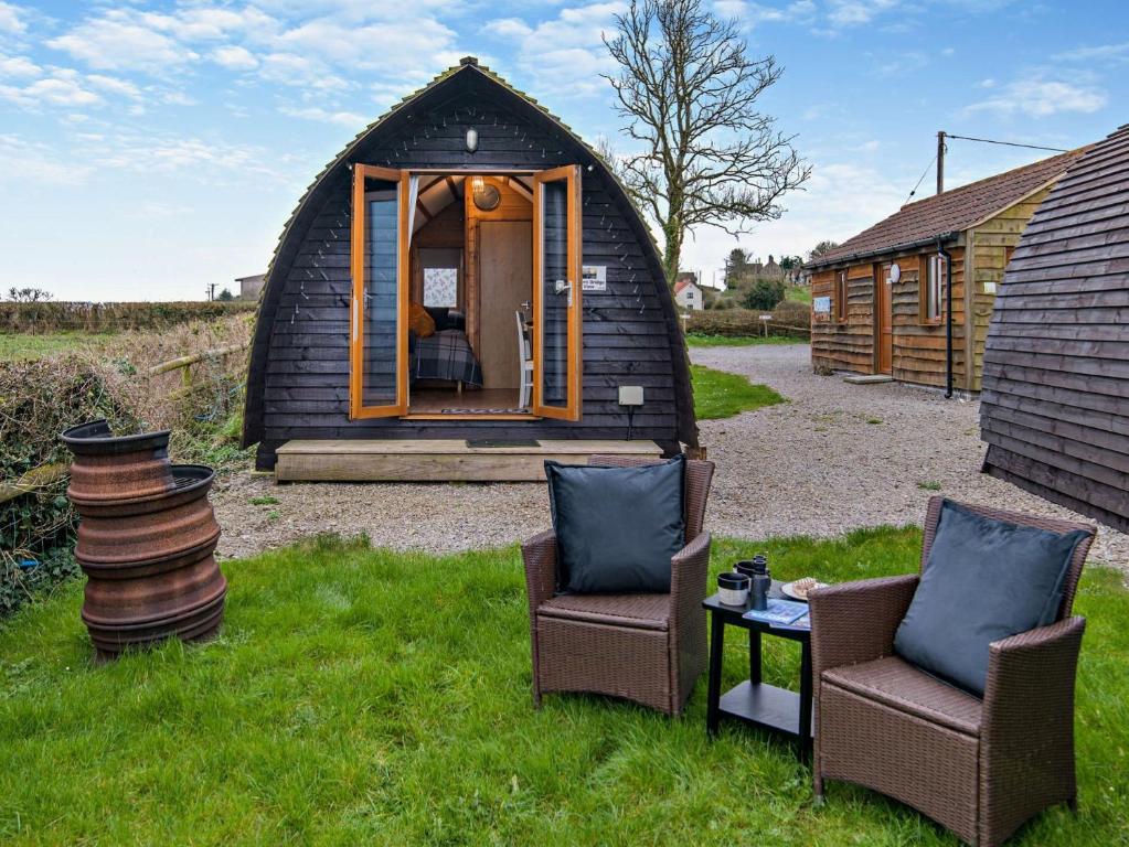 a black igloo house with two chairs and a table at 1 Bed in Bristol 94006 in Chew Magna