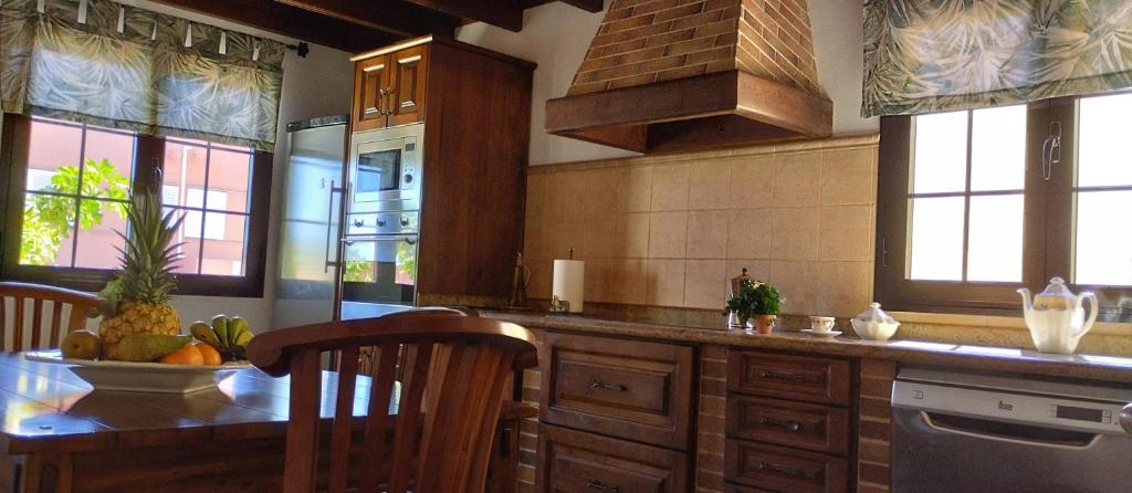 a kitchen with a table with a bowl of fruit on it at AKASHA in Puerto del Rosario