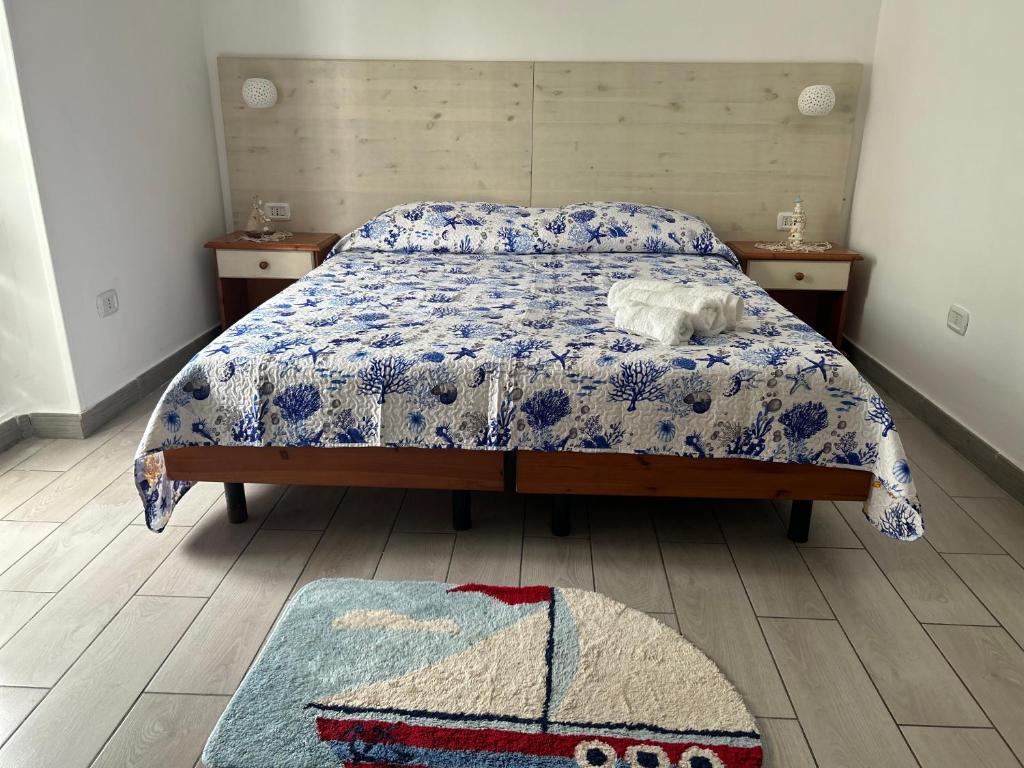 a bedroom with a bed and two tables and a rug at Lilli's House in Gallipoli
