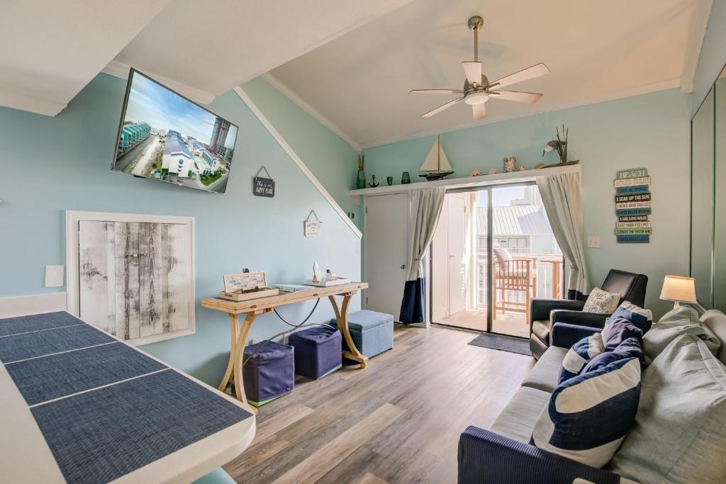 a living room with a couch and a tv on the wall at Sugar Beach 301 by Vacation Homes Collection in Gulf Shores