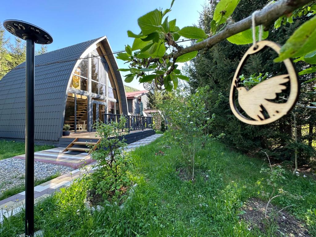 a house with a garden and a tree at U Yaroslava Hotel in Yaremche