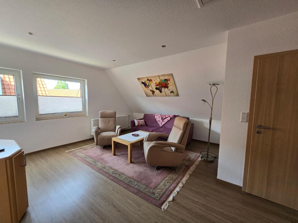 uma sala de estar com um sofá, cadeiras e uma mesa em Warendorf 12 em Warendorf