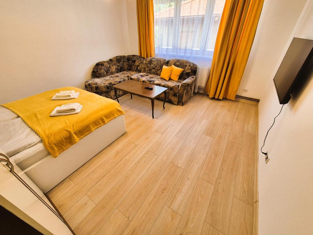 a view of a bedroom with a bed and a couch at Old Town Bistrik - Free parking in Sarajevo