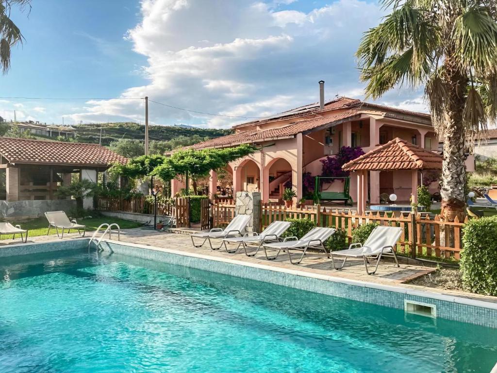 a house with a swimming pool in front of a house at Villa Fiorita in Casal Velino