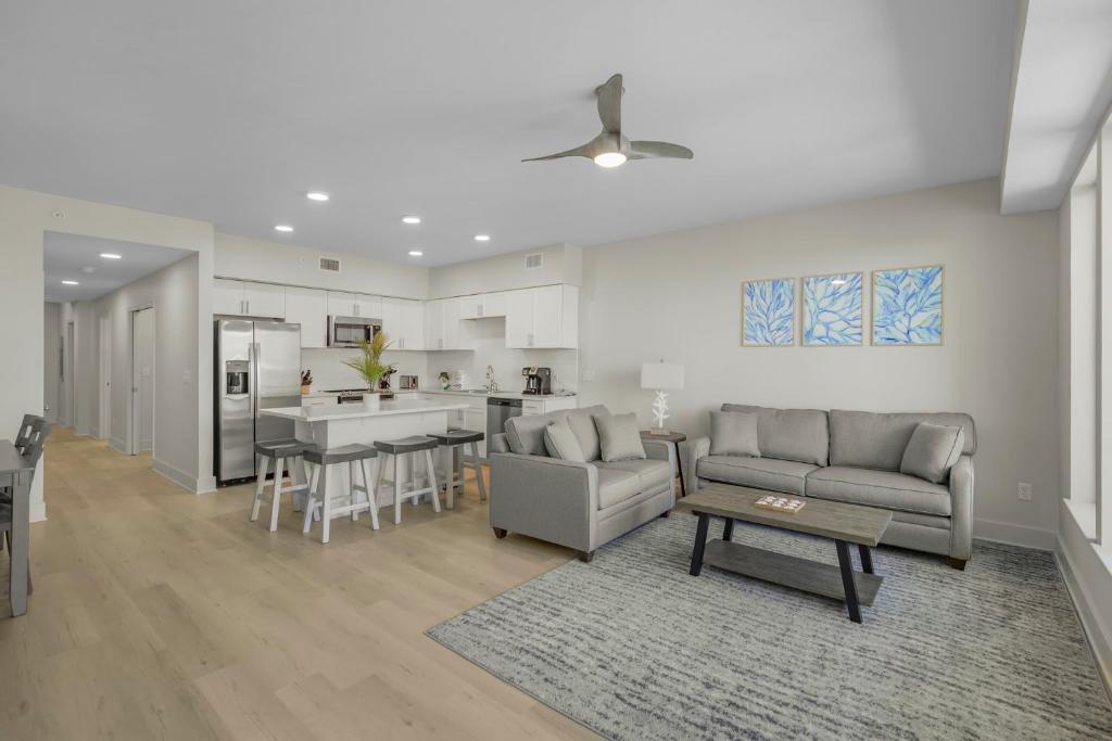 a living room with a couch and a table and a kitchen at Sea Glass 316 by Vacation Homes Collection in Gulf Shores