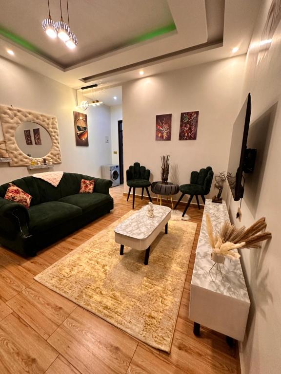 a living room with a couch and a table at Lyrrh Homes Apartments in Kira