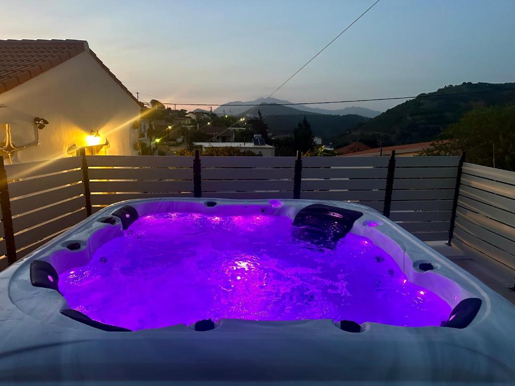 a hot tub with purple lighting on a balcony at Villa Eftychia Serene Getaway with Hot Tub in a Quiet Location in Kissamos