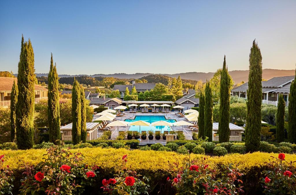 a resort with a swimming pool and trees and flowers at Rosewood Sand Hill in Menlo Park