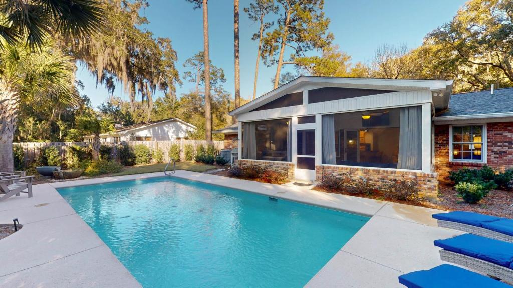 a swimming pool in the backyard of a house at A LIFELONG DREAM home in Jekyll Island
