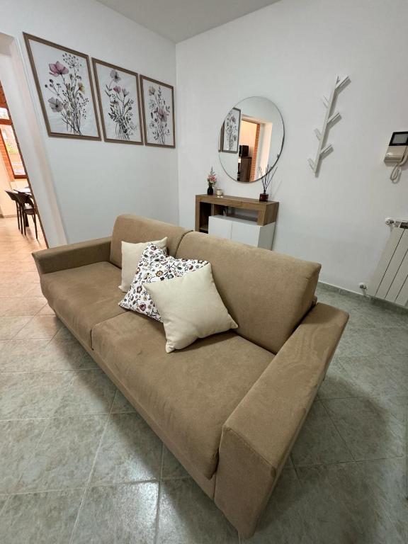 brązowa kanapa w salonie z lustrem w obiekcie LIKE HOME w mieście Norma