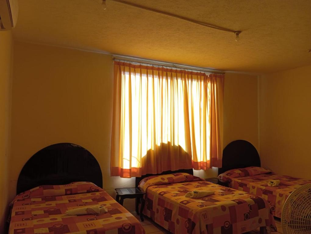 Postel nebo postele na pokoji v ubytování Hotel Juarez