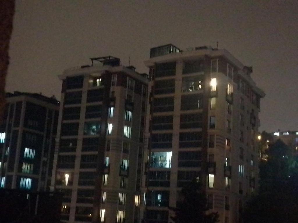 dos edificios altos con sus luces encendidas por la noche en Miracle HYLen Hotel, en Estambul