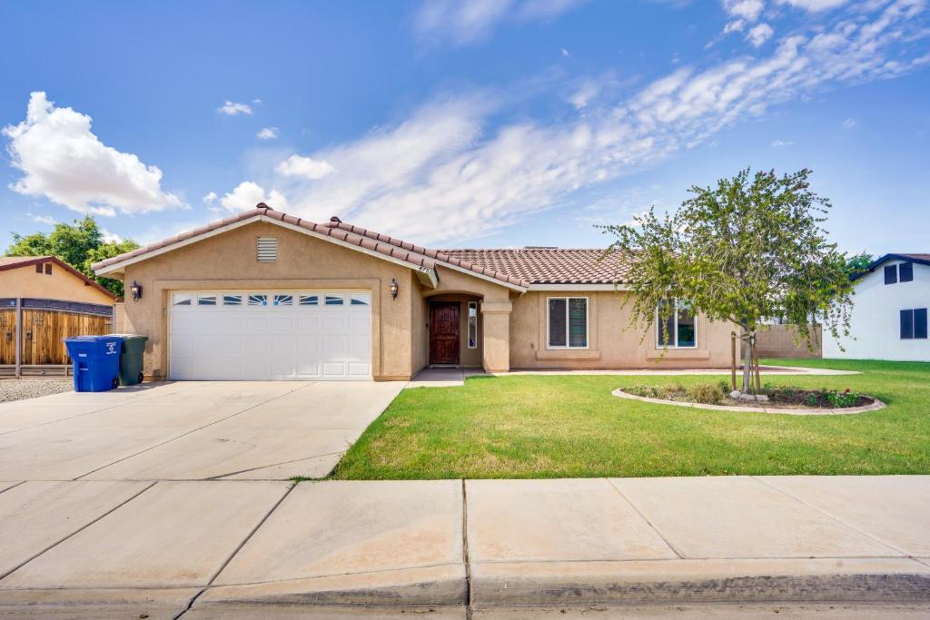 a house with a driveway and a garage at Yuma Family Home with Covered Patio and Grill! in Yuma
