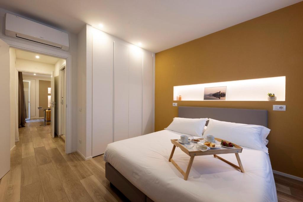 a bedroom with a bed with a tray of food on it at Residence Casa Coppa Appartamento Ivy in Omegna