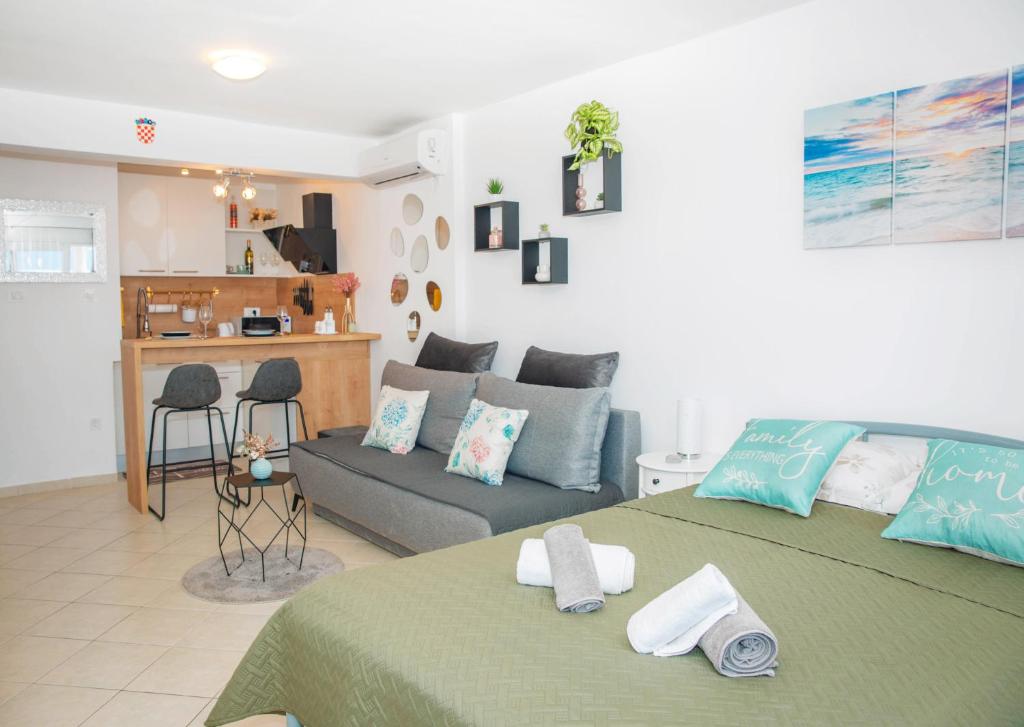 a living room with a bed and a couch at Studio apartman MATEO in Blace
