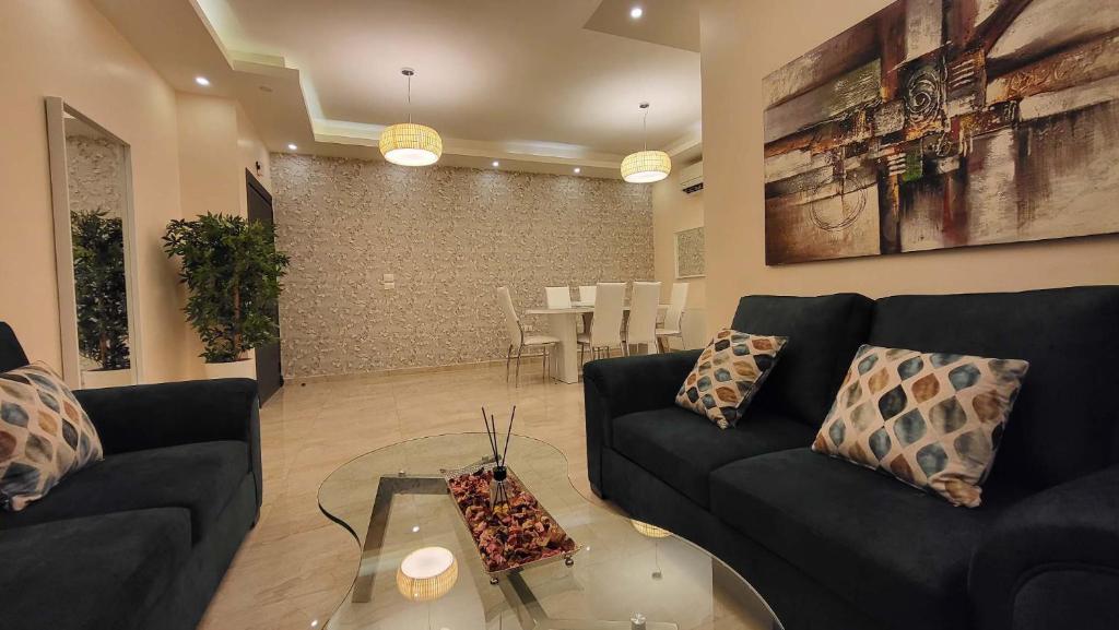 a living room with a couch and a table at Western Gate Residence 2 Amman in Amman