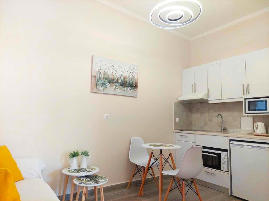 a kitchen with a couch and a table and chairs at Panayota Apartments in Kassiopi