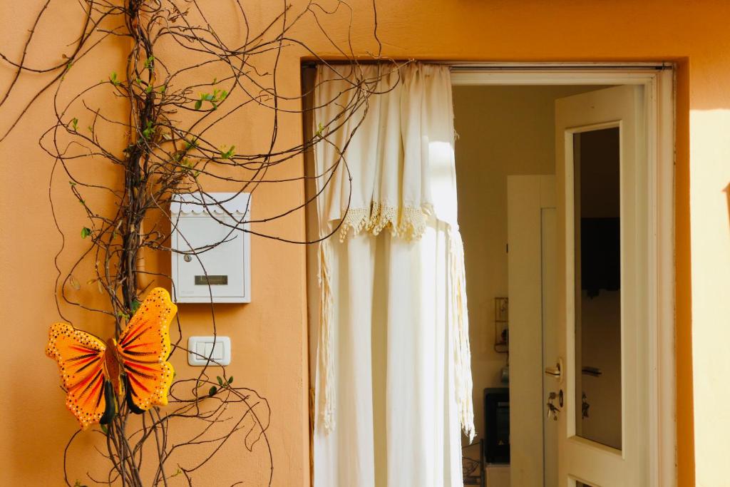 a butterfly on a wall next to a window at Casa vacanze Il Chicchino in Rocca San Giovanni