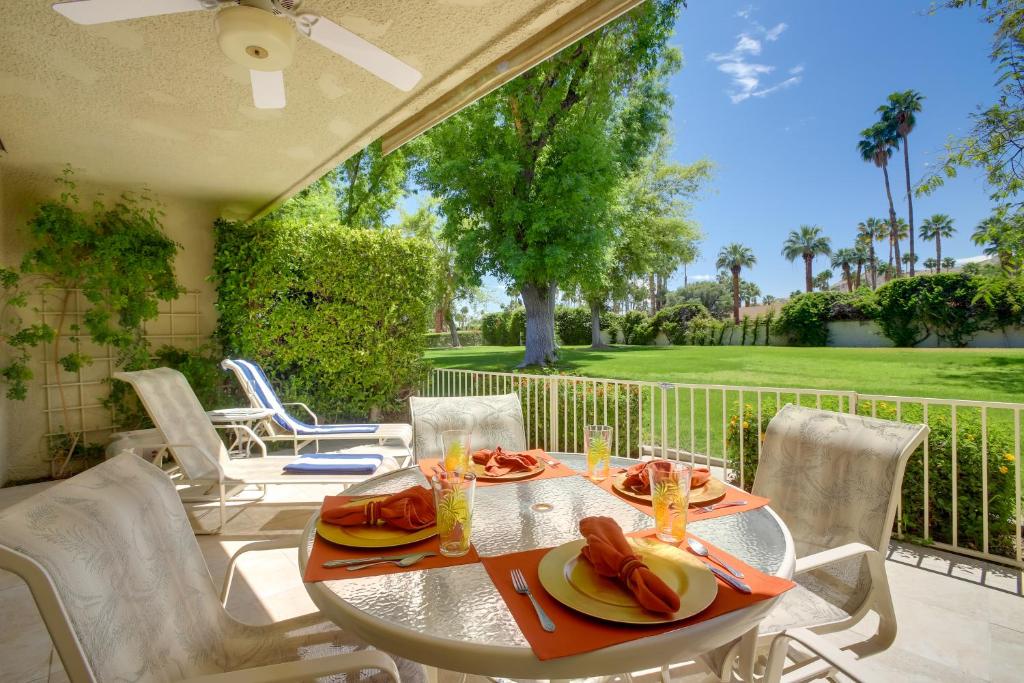 a table with plates of food on a patio at Sunny Palm Springs Haven Fenced Patio, 6 Pools! in Palm Springs