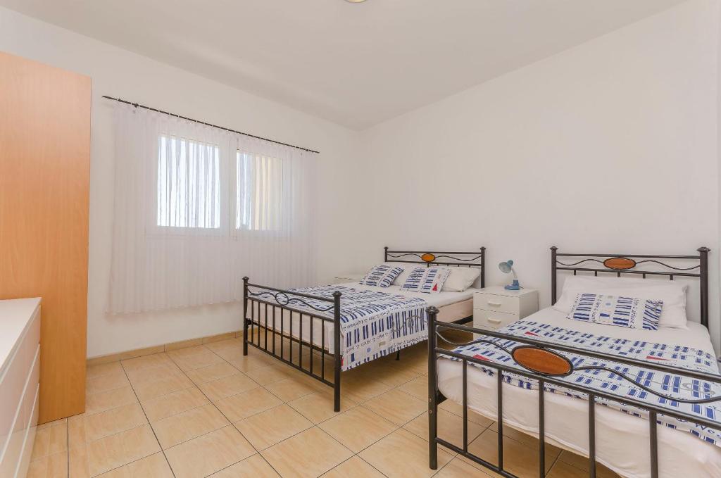 Postel nebo postele na pokoji v ubytování Apartments Sweet Escape