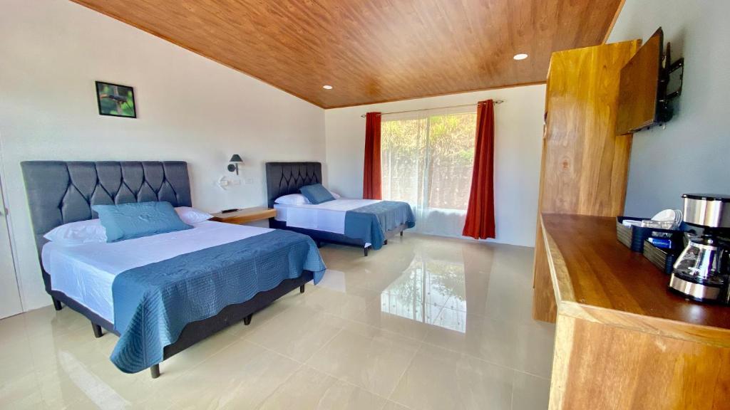 a bedroom with two beds and a television in it at Canto Del Bosque in San Vito
