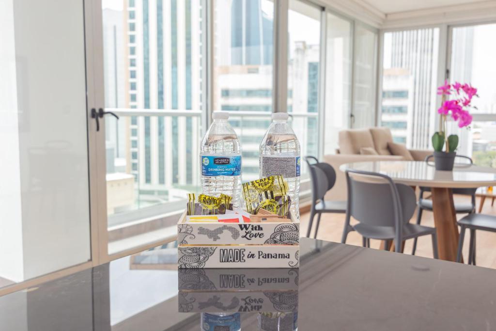 two bottles of water sitting on top of a table at Boutique Apartments Panamá Marbella in Loma del Naranjo
