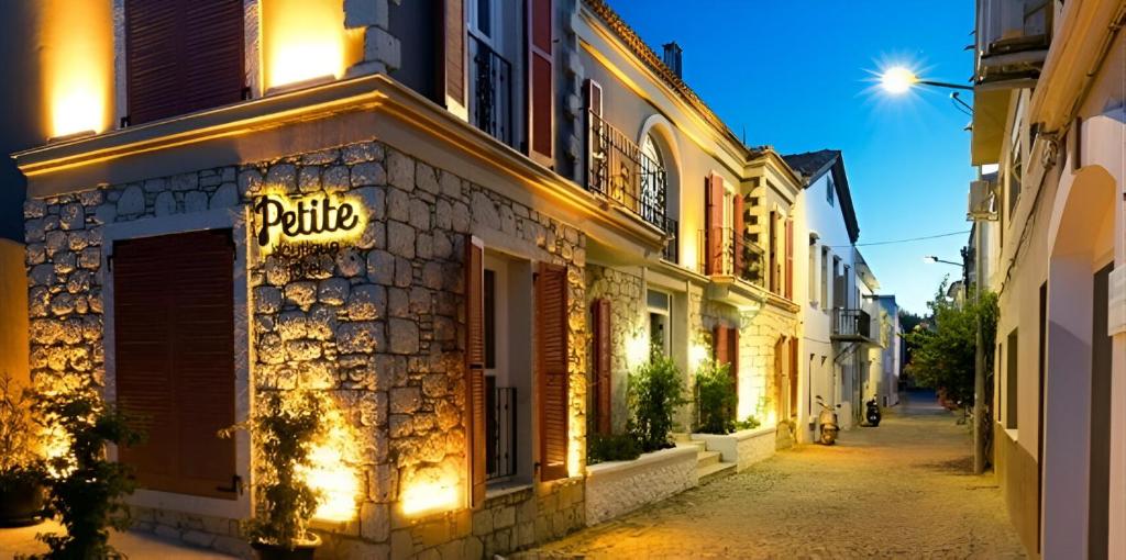 a street with a pub sign on the side of a building at Petite Boutique Hotel in Ildır