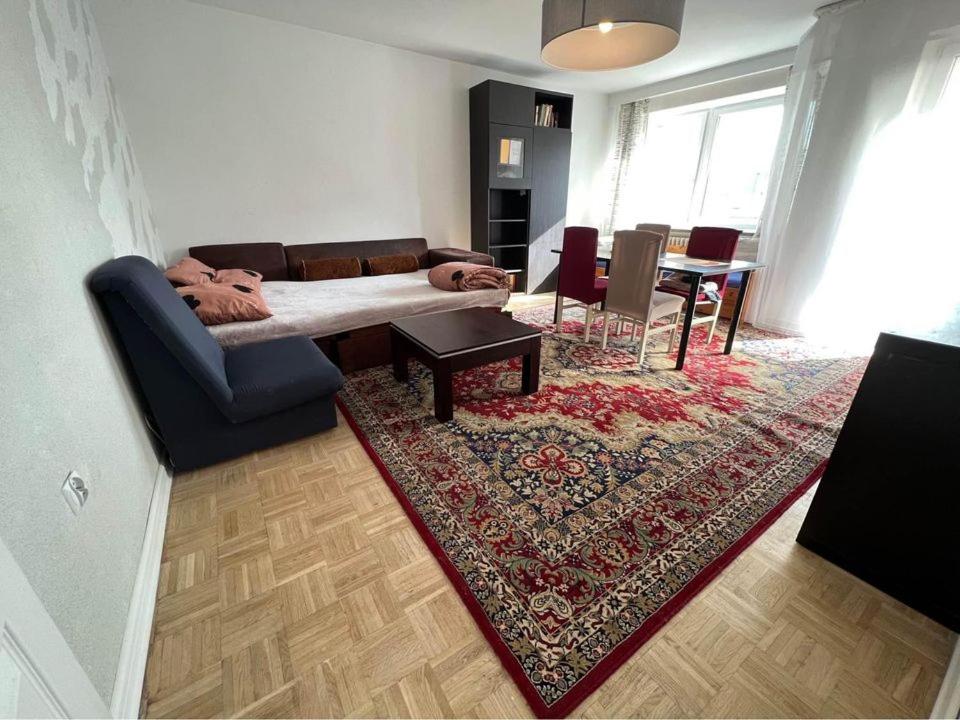 a living room with a couch and a table at Warsaw Lux Rooms in Warsaw
