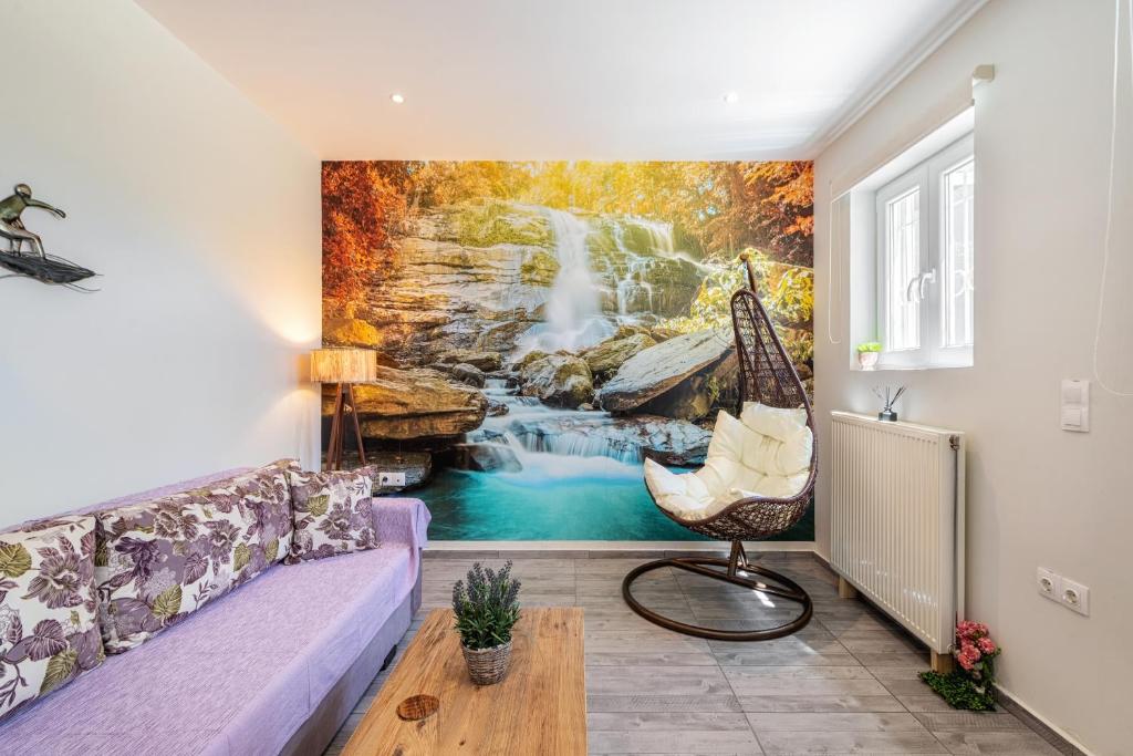 a living room with a waterfall mural on the wall at Kassiani-Sofia Cottage in Gouvia