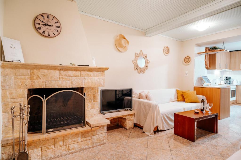 a living room with a couch and a fireplace at The Traditional House of Molivos in Mythimna